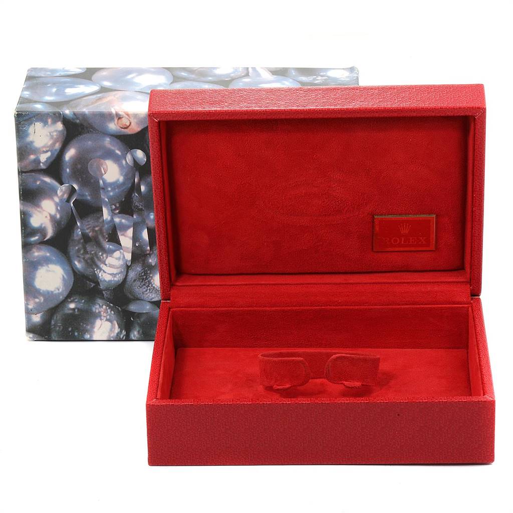 This image shows an open, red Rolex watch box for the President model.