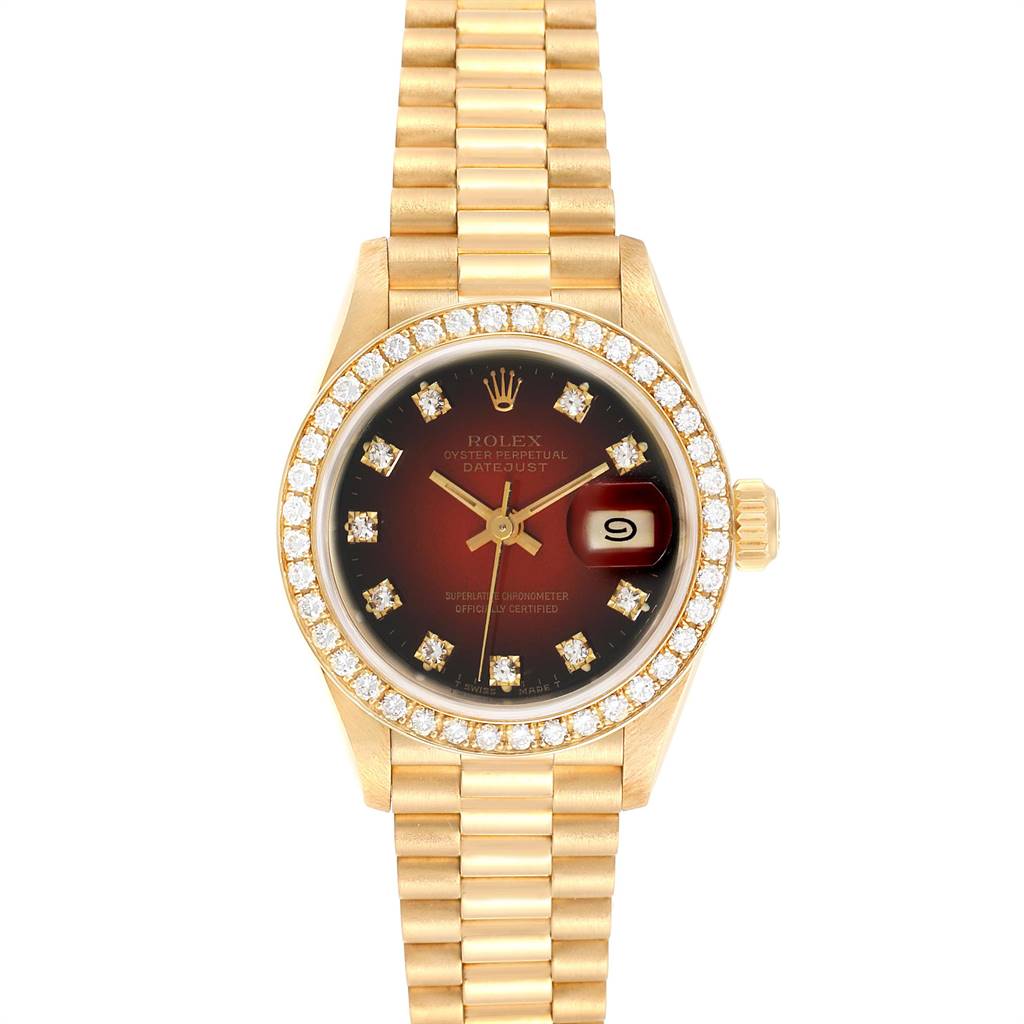 This image shows a Rolex President 69138 Yellow Gold Red Dial 69138 Yellow Gold Red Dial model watch, featuring a full frontal view with a gold bracelet, diamond bezel, and date display.