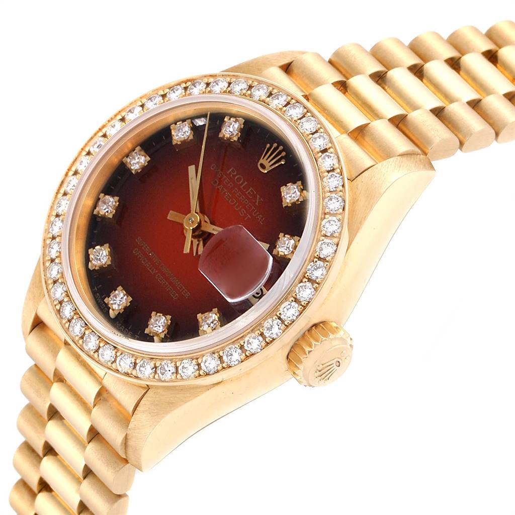 This image shows a close-up view of the Rolex President 69138 Yellow Gold Red Dial 69138 Yellow Gold Red Dial model watch, highlighting the dial, bezel, and part of the bracelet.
