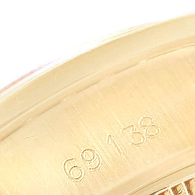 This close-up image shows the model number "69138" engraved on the casing of a Rolex President 69138 Yellow Gold Red Dial 69138 Yellow Gold Red Dial watch.