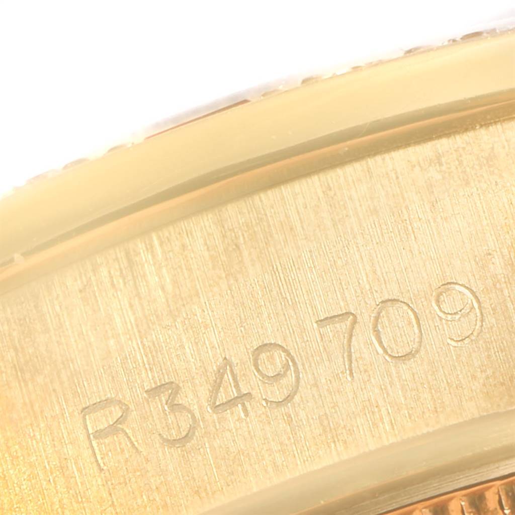 This close-up image shows the engraved serial number on the case of a Rolex President 69068 Women's Yellow Gold Champagne Dial 69068 Women's Yellow Gold Champagne Dial model watch.