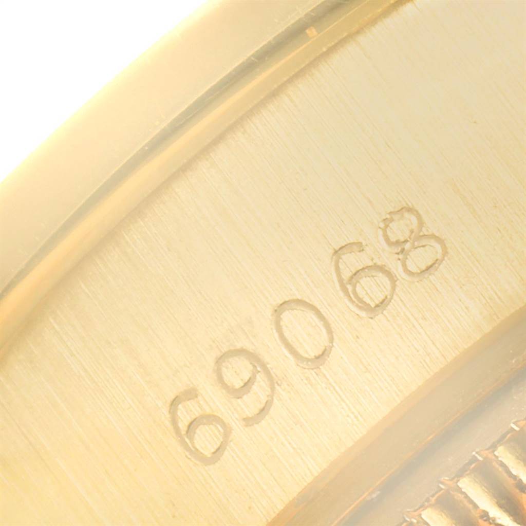 The image shows a close-up view of the case back rim with the engraved serial number of a Rolex President 69068 Women's Yellow Gold Champagne Dial 69068 Women's Yellow Gold Champagne Dial model watch.