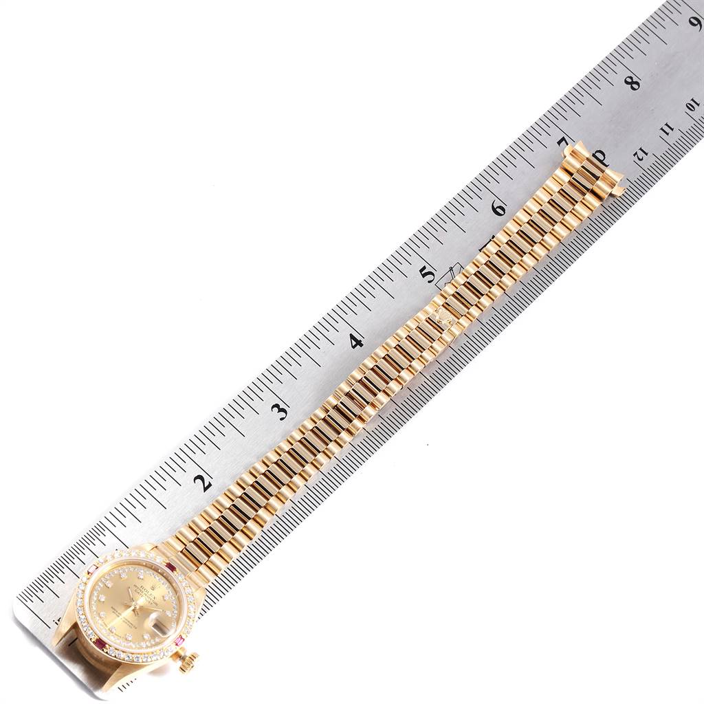This image shows a Rolex President 69068 Women's Yellow Gold Champagne Dial 69068 Women's Yellow Gold Champagne Dial watch laid flat with a ruler for scale, showcasing the bracelet and face.
