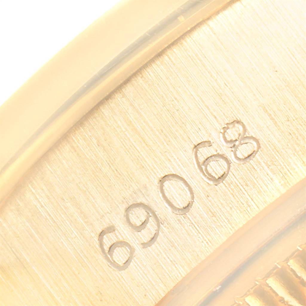 This image shows a close-up of the serial number engraving on the case of a Rolex President 69068 Women's Yellow Gold Champagne Dial 69068 Women's Yellow Gold Champagne Dial model watch.
