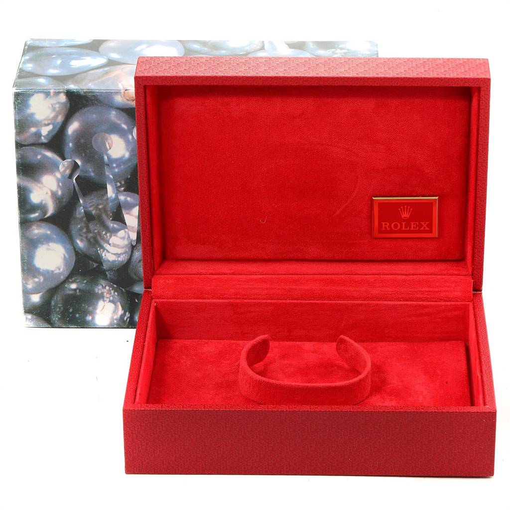 The image shows an open red Rolex presentation box for the President model, revealing the inner lining and watch holder.