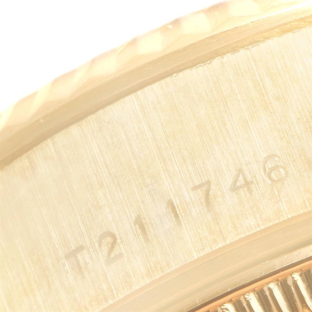 This close-up image shows the engraved serial number on the side case of a Rolex President 69178 Women's Yellow Gold White Dial 69178 Women's Yellow Gold White Dial model watch.