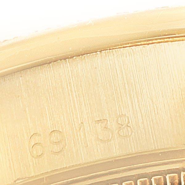 This image shows a close-up of the side of the bezel of a Rolex President 69138 Women's Yellow Gold Blue Dial 69138 Women's Yellow Gold Blue Dial model watch, with part of the reference number 69138 visible.