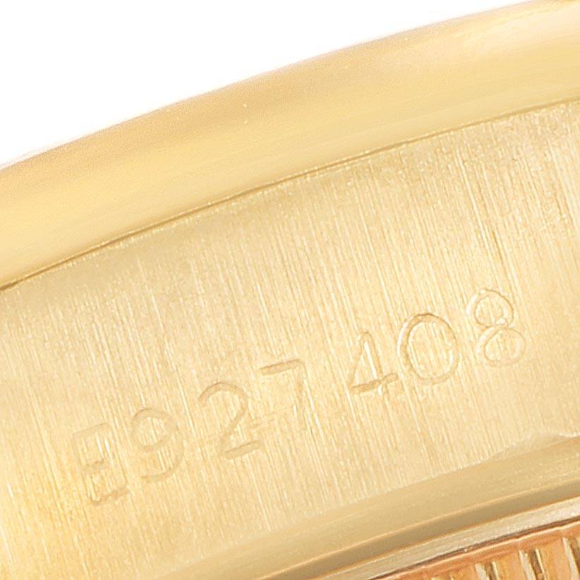 This image shows a close-up of the serial number engraved on the side of a Rolex President 69138 Women's Yellow Gold Blue Dial 69138 Women's Yellow Gold Blue Dial model watch bezel.