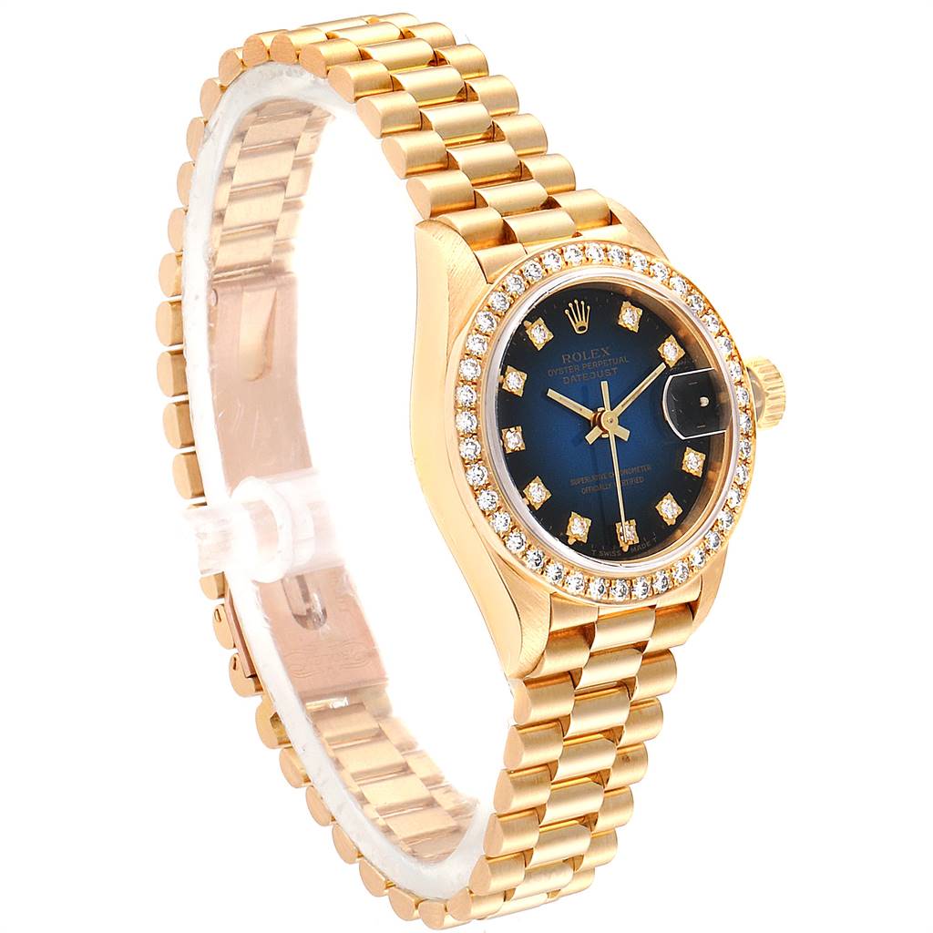 The Rolex President 69138 Women's Yellow Gold Blue Dial 69138 Women's Yellow Gold Blue Dial model watch is shown at a three-quarter angle, highlighting its gold bracelet, blue dial, diamond bezel, and crown.