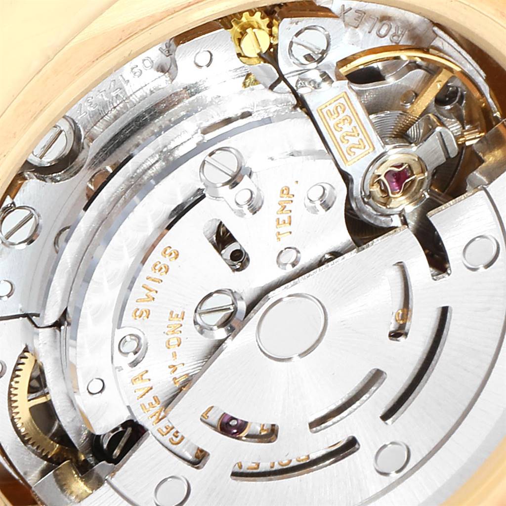 The image shows a close-up of the inner mechanism of a Rolex President 179178 Women's Yellow Gold Mother of Pearl Dial 179178 Women's Yellow Gold Mother of Pearl Dial model watch, highlighting its gears and intricate components.