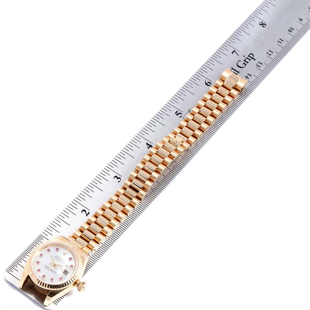 The photo shows a Rolex President 179178 Women's Yellow Gold Mother of Pearl Dial 179178 Women's Yellow Gold Mother of Pearl Dial model watch from a top-down angle, laid out alongside a ruler.
