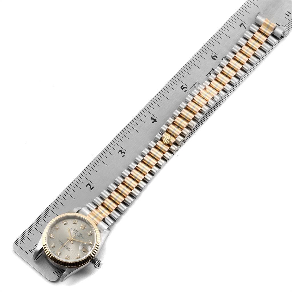 The image shows the Rolex President 68279 Women's White Gold Silver Dial 68279 Women's White Gold Silver Dial watch laid flat next to a ruler, highlighting its gold and silver bracelet and watch face.