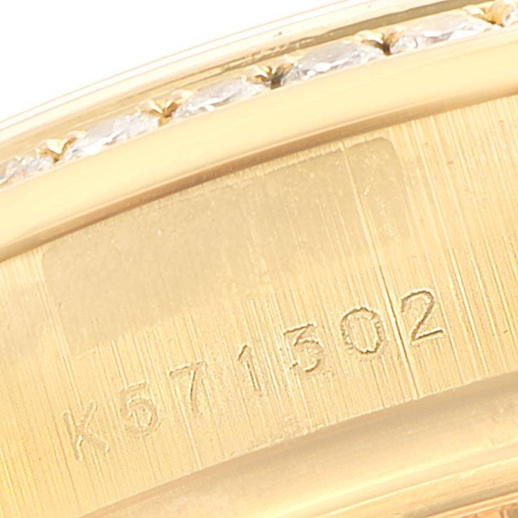 This image shows a close-up of the inner side of a Rolex President 179158 Women's Yellow Gold Silver Dial 179158 Women's Yellow Gold Silver Dial model watch band, displaying serial numbers engraved on it.