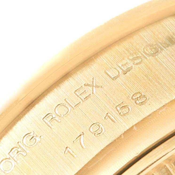 The image shows a close-up of the engraving on the inner bezel of a Rolex President 179158 Women's Yellow Gold Silver Dial 179158 Women's Yellow Gold Silver Dial model watch.