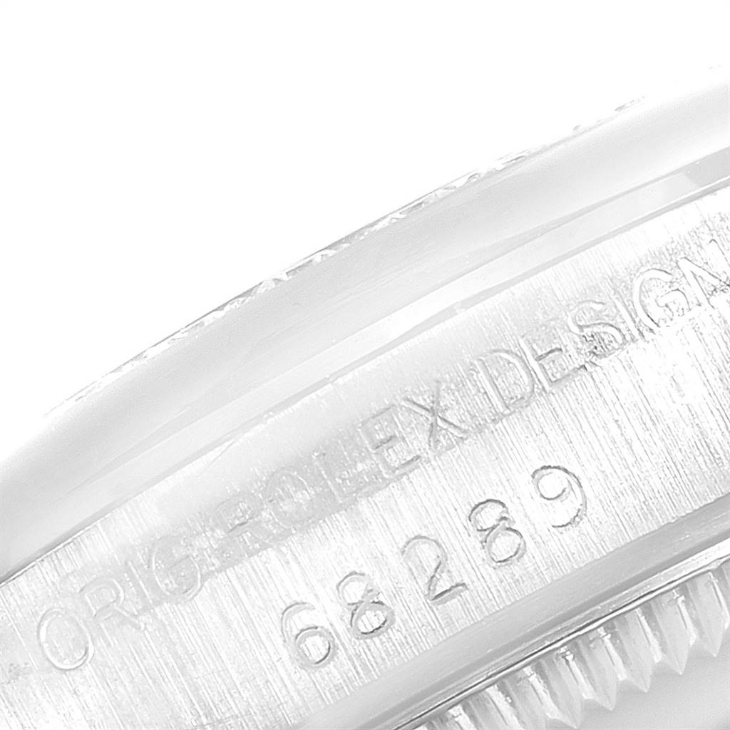 The image shows a close-up view of the engraved side bezel and case number of the Rolex President 68289 Women's White Gold Black Dial 68289 Women's White Gold Black Dial model.