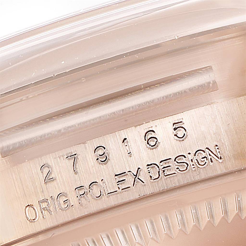 This close-up image shows the side of the case and bezel of a Rolex President 279165 Women
s Rose Gold Brown Dial 279165 Women
s Rose Gold Brown Dial model watch, focusing on its serial and design numbers.