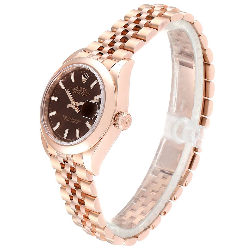 The image shows a side angle of a Rolex President 279165 Women
s Rose Gold Brown Dial 279165 Women
s Rose Gold Brown Dial model watch, highlighting its rose gold bracelet, crown, and black dial with date display.