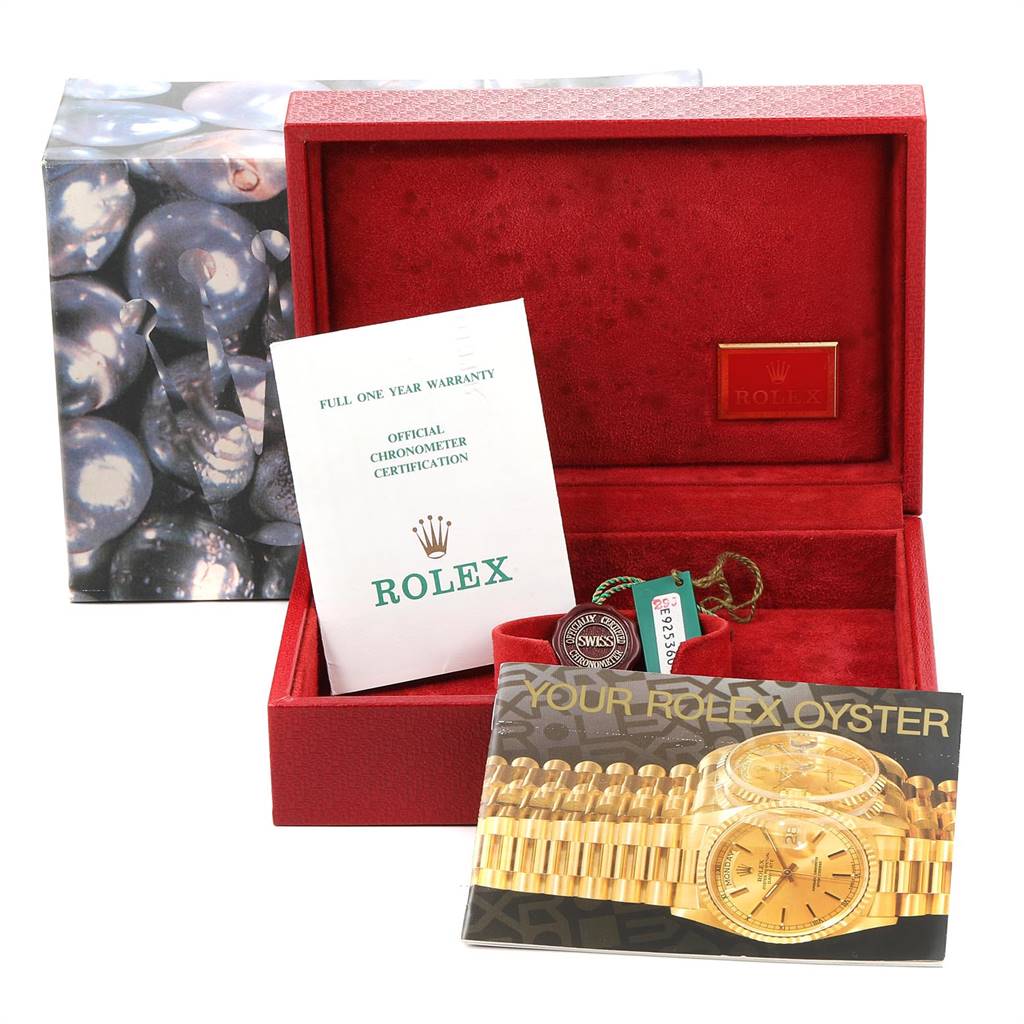 The image shows the packaging and accessories, including a warranty card and booklet, for a Rolex President 69178 Women's Yellow Gold Silver Dial 69178 Women's Yellow Gold Silver Dial model watch.