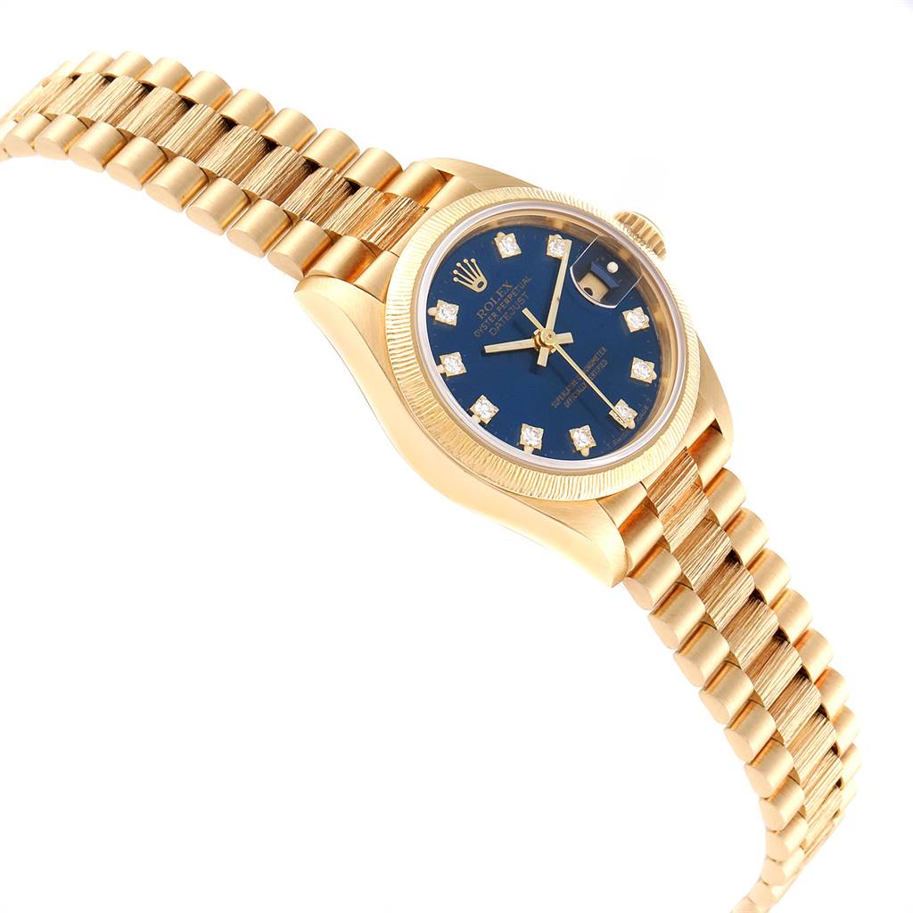 This image shows a Rolex President 69278 Women's Yellow Gold Blue Dial 69278 Women's Yellow Gold Blue Dial model watch at a slight angle, highlighting the gold bracelet, blue dial, and the fluted bezel.