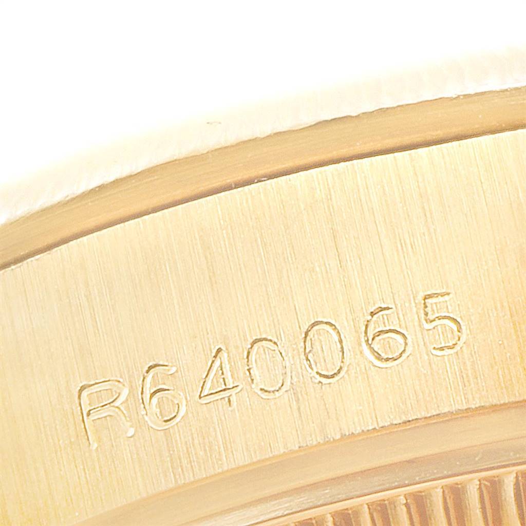 This image shows a close-up of the side of the case of a Rolex President 69278 Women's Yellow Gold Blue Dial 69278 Women's Yellow Gold Blue Dial model, displaying its engraved serial number.