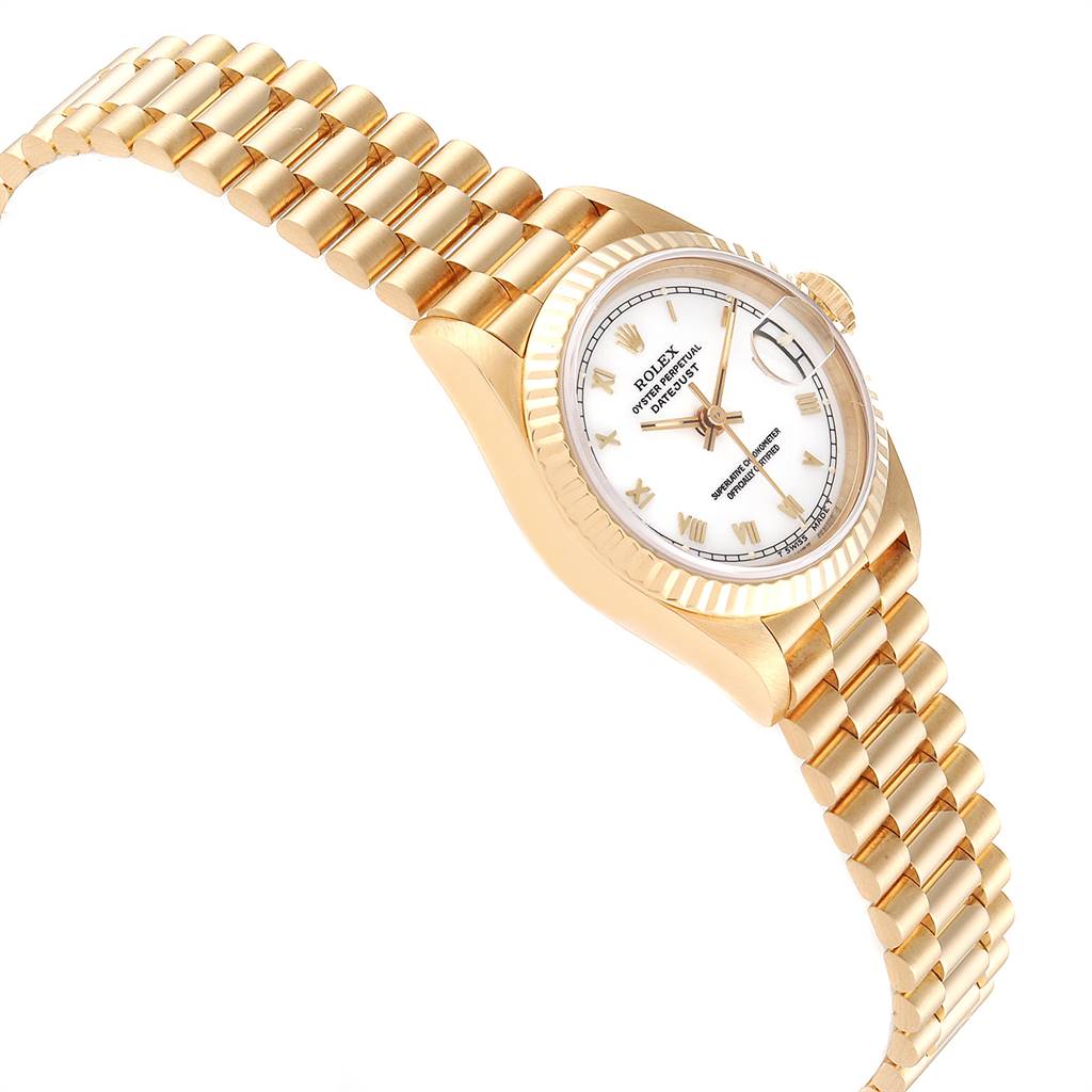 The image shows a Rolex President 69178 Women
s Yellow Gold White Dial 69178 Women
s Yellow Gold White Dial model watch from an angled side view, highlighting the band, dial, and crown.