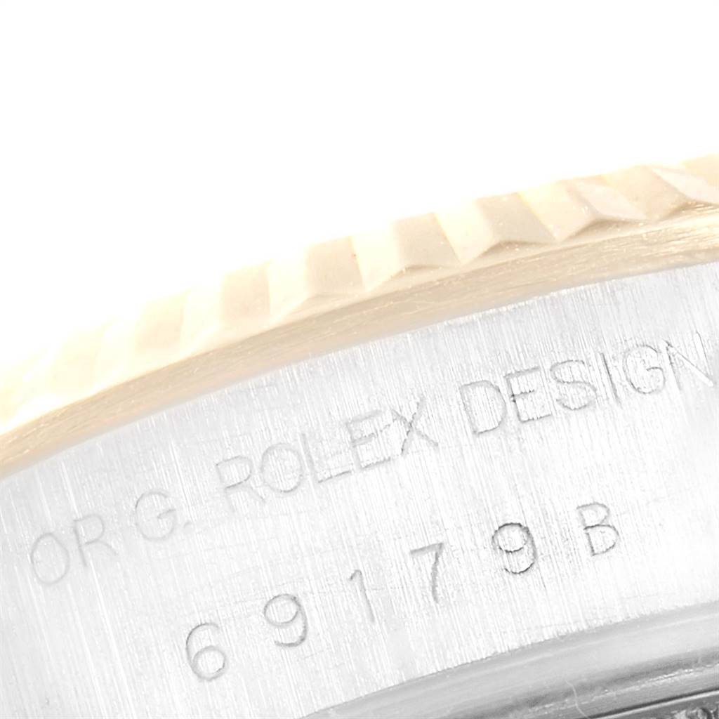 This image shows a close-up of the engraved side of the bezel and case of the Rolex President 69179 Women's White Gold Red Dial 69179 Women's White Gold Red Dial model.