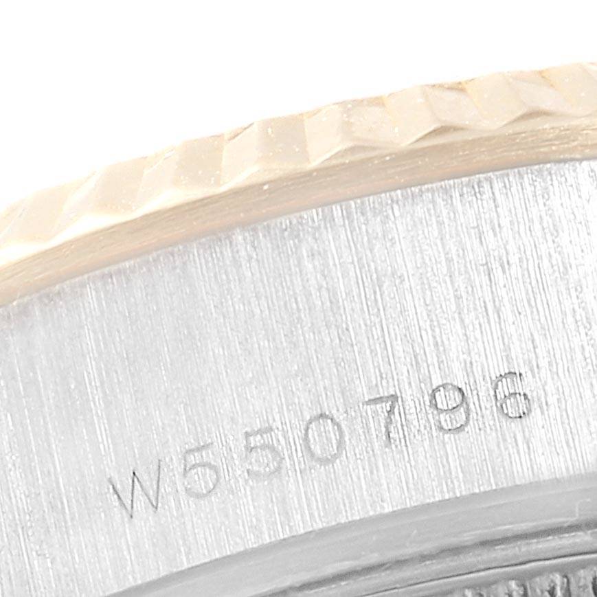 The image shows a close-up of the Rolex President 69179 Women's White Gold Red Dial 69179 Women's White Gold Red Dial watch bezel and part of the serial number on the case.