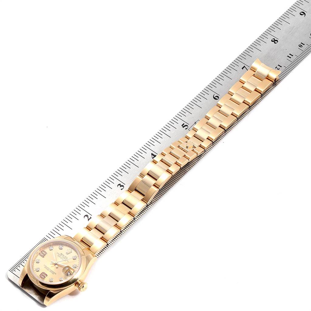 The image shows a Rolex President 178248 Women
s Yellow Gold Champagne Dial 178248 Women
s Yellow Gold Champagne Dial watch partially unrolled next to a ruler, mainly displaying the bracelet and watch face.
