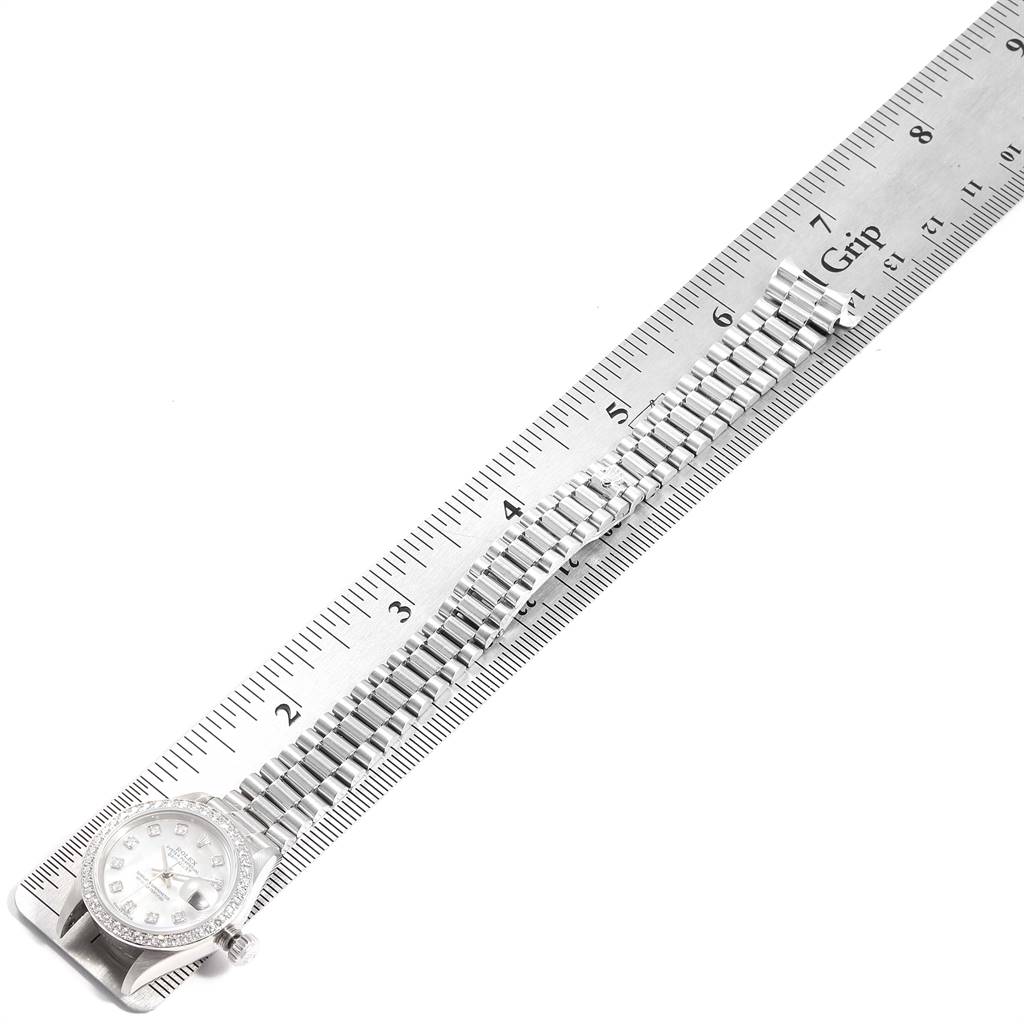 This image shows a side angle of a Rolex President 79136 Women's Platinum Mother of Pearl Dial 79136 Women's Platinum Mother of Pearl Dial model watch with its bracelet measured against a ruler.