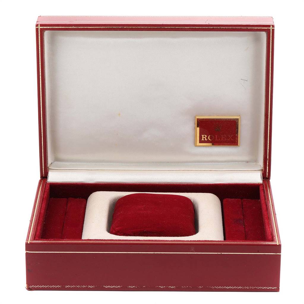 This image shows an open red Rolex box designed for the President model, displaying its cushioned interior and brand logo.