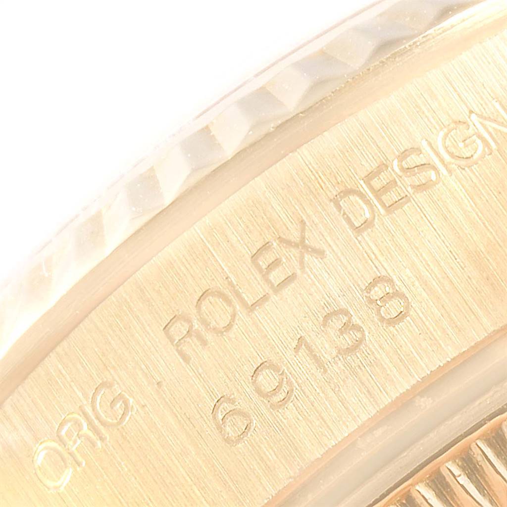 The image shows a close-up of the case back with the model number and part of the fluted bezel of a Rolex President 69138 Women
s Yellow Gold White Dial 69138 Women
s Yellow Gold White Dial watch.