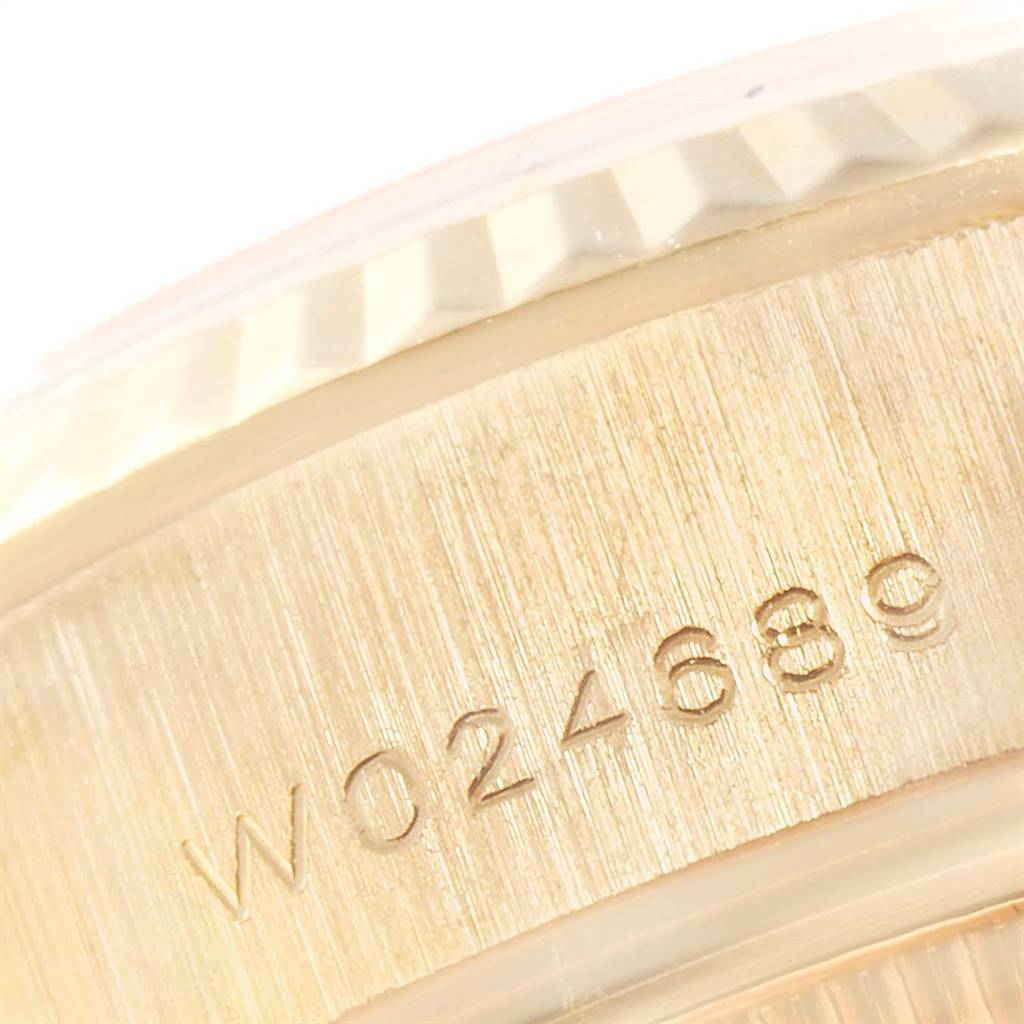 The image shows a close-up of the serial number engraving on the case back of a Rolex President 69138 Women
s Yellow Gold White Dial 69138 Women
s Yellow Gold White Dial model watch.