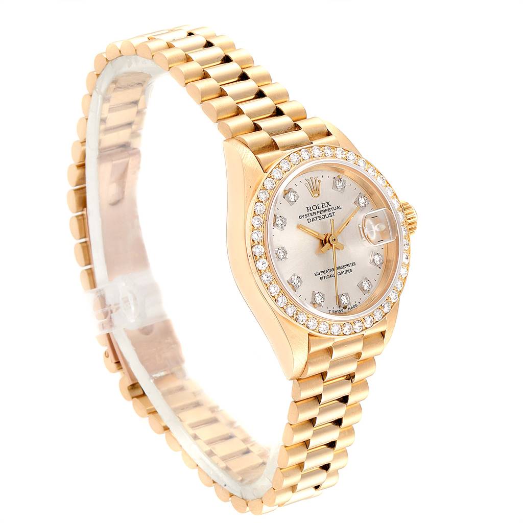 The image shows a Rolex President 69138 Women's Yellow Gold Silver Dial 69138 Women's Yellow Gold Silver Dial model watch in a three-quarter view, highlighting the gold bracelet, diamond bezel, and dial.