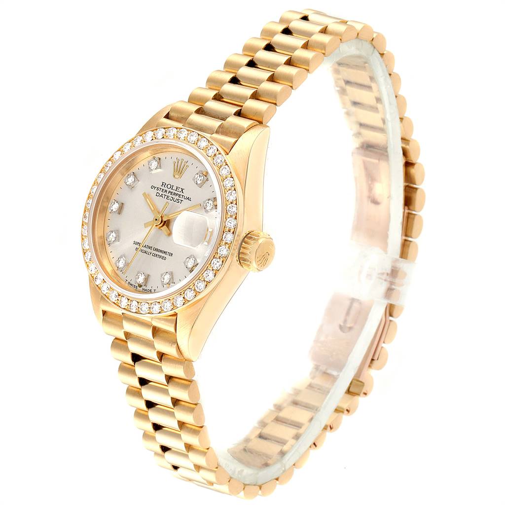 The image shows a gold Rolex President 69138 Women's Yellow Gold Silver Dial 69138 Women's Yellow Gold Silver Dial model watch at a side angle, highlighting the diamond bezel, dial, and bracelet.