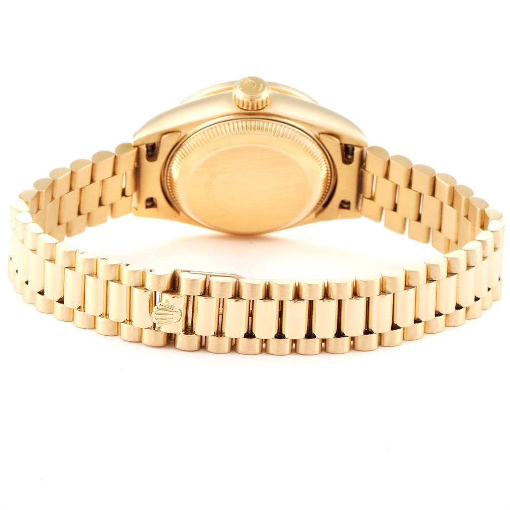 The image shows the back view of a Rolex President 69138 Women's Yellow Gold Silver Dial 69138 Women's Yellow Gold Silver Dial model watch, highlighting the case back and the gold bracelet with a clasp.