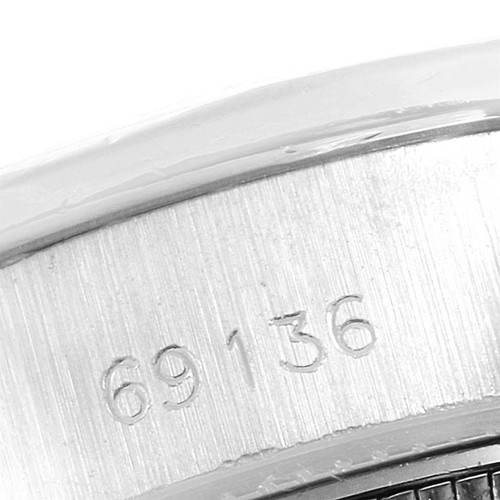 The image shows a close-up angle of the caseback and serial number of a Rolex President 69136 Women's Platinum Silver Dial 69136 Women's Platinum Silver Dial model watch.