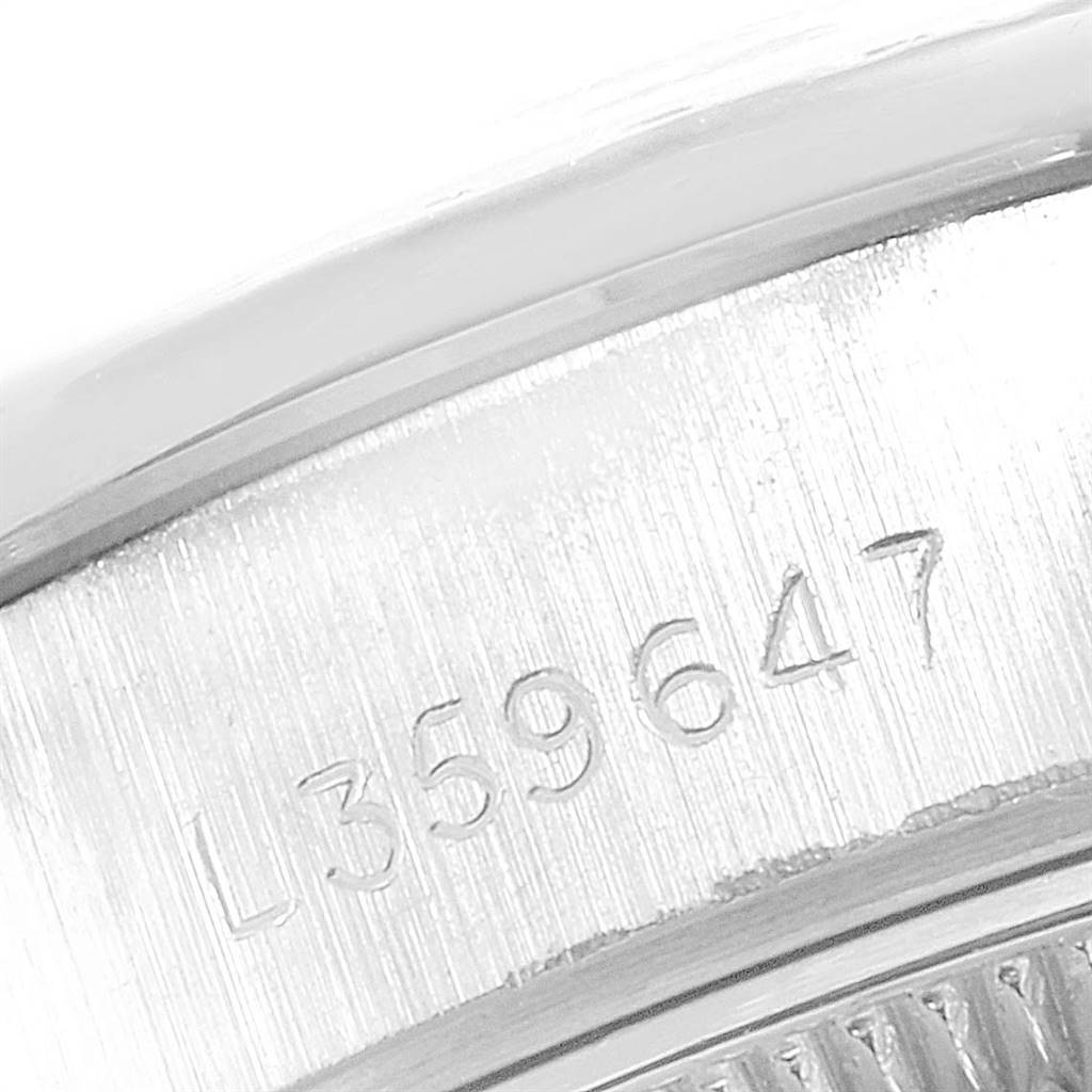 The image shows a close-up angle of a serial number engraved on the case of a Rolex President 69136 Women's Platinum Silver Dial 69136 Women's Platinum Silver Dial model watch.