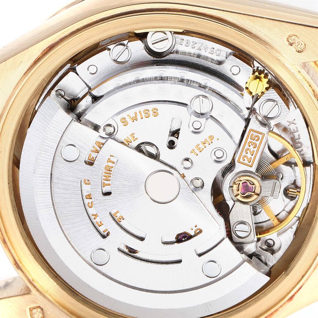 This image shows the intricate inner mechanics of a Rolex President 79158 Women
s Yellow Gold Champagne Dial 79158 Women
s Yellow Gold Champagne Dial model watch, focusing on the movement and components like the rotor and balance wheel.