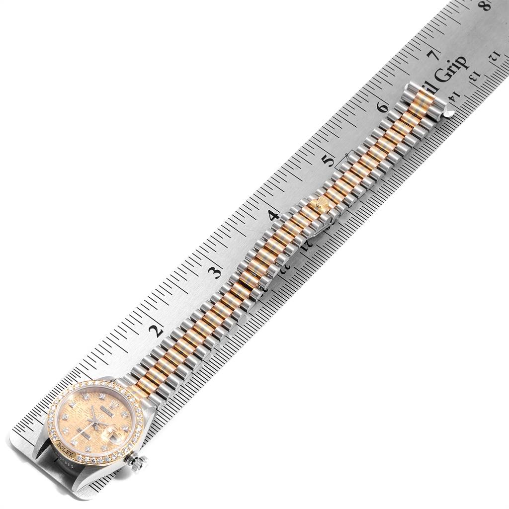 The Rolex President 69149 Women's White Gold Brown Dial 69149 Women's White Gold Brown Dial watch is shown flat, face up, with the bracelet and case aligned along a measuring ruler.