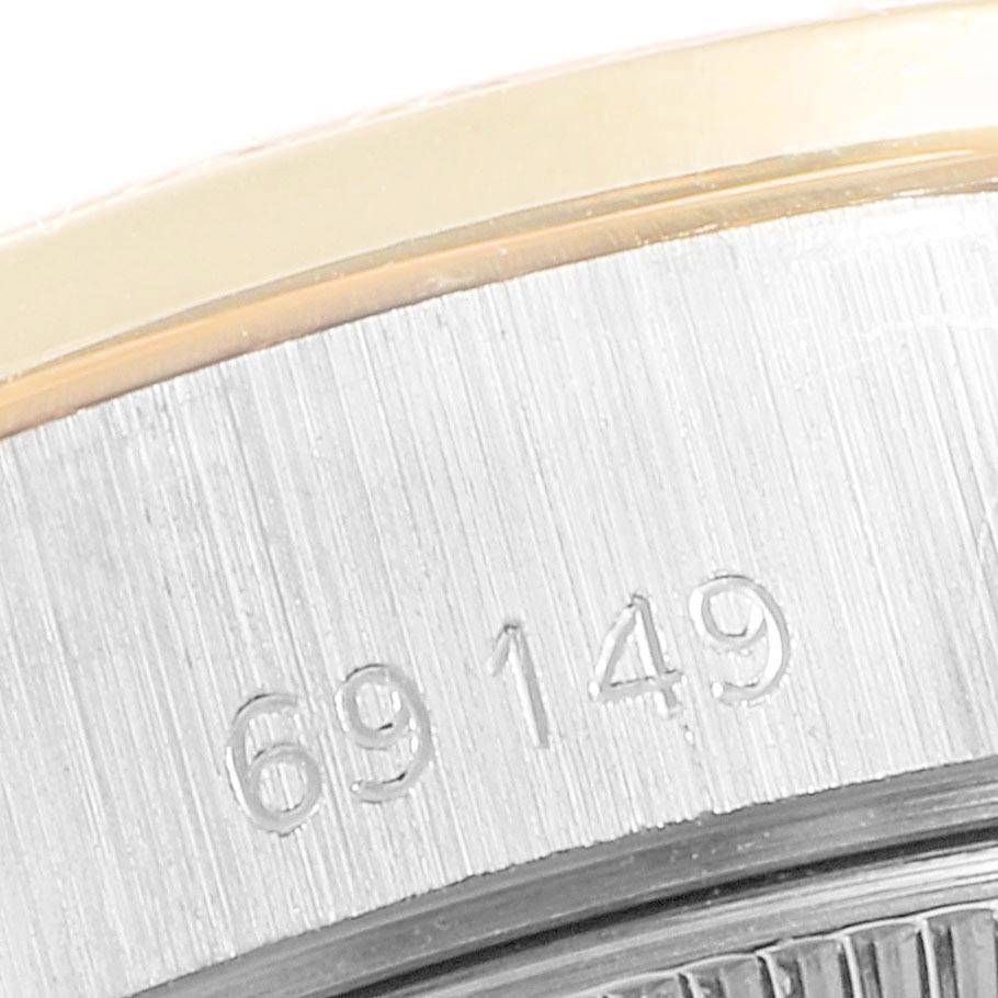 This close-up shows the side, including the serial number, of a Rolex President 69149 Women's White Gold Brown Dial 69149 Women's White Gold Brown Dial model watch.