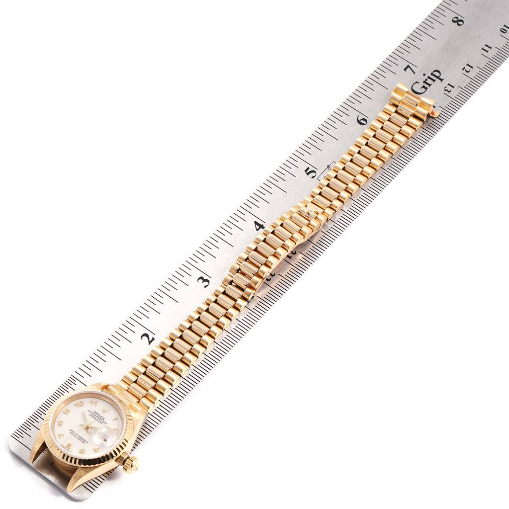 The image shows a Rolex President 69178 Women's Yellow Gold Beige Dial 69178 Women's Yellow Gold Beige Dial model watch laid flat against a ruler, displaying the watch face and bracelet.