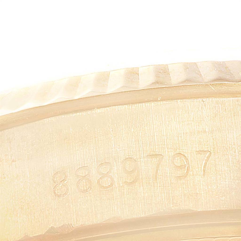The image shows the engraved serial number on the back case of a Rolex President 69178 Women's Yellow Gold Beige Dial 69178 Women's Yellow Gold Beige Dial model watch at a close-up angle.