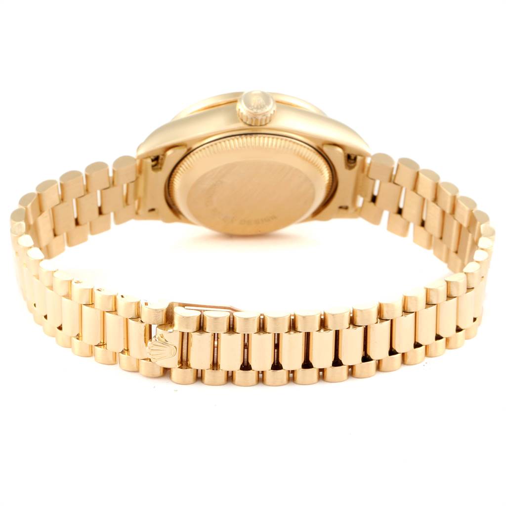 The image shows the back view and bracelet of a Rolex President 69138 Women
s Yellow Gold Champagne Dial 69138 Women
s Yellow Gold Champagne Dial model watch, highlighting the band
s clasp and case back.