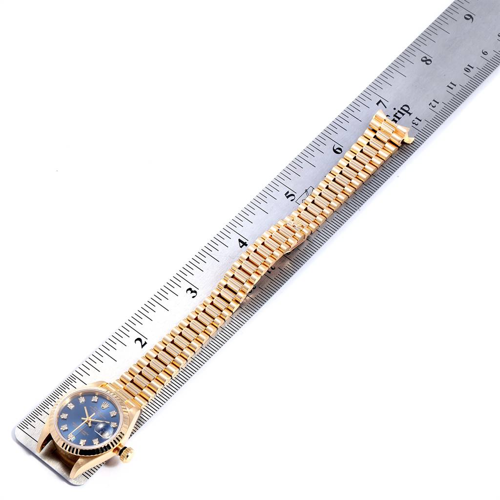 The image shows a Rolex President 69178 Women's Yellow Gold Blue Dial 69178 Women's Yellow Gold Blue Dial watch, positioned alongside a ruler, displaying both the watch face and full band.