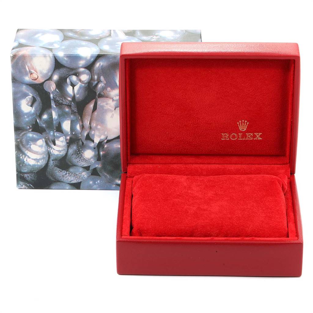 The image shows the opened box for the President model by Rolex, featuring red interior cushioning and the brand logo inside.  