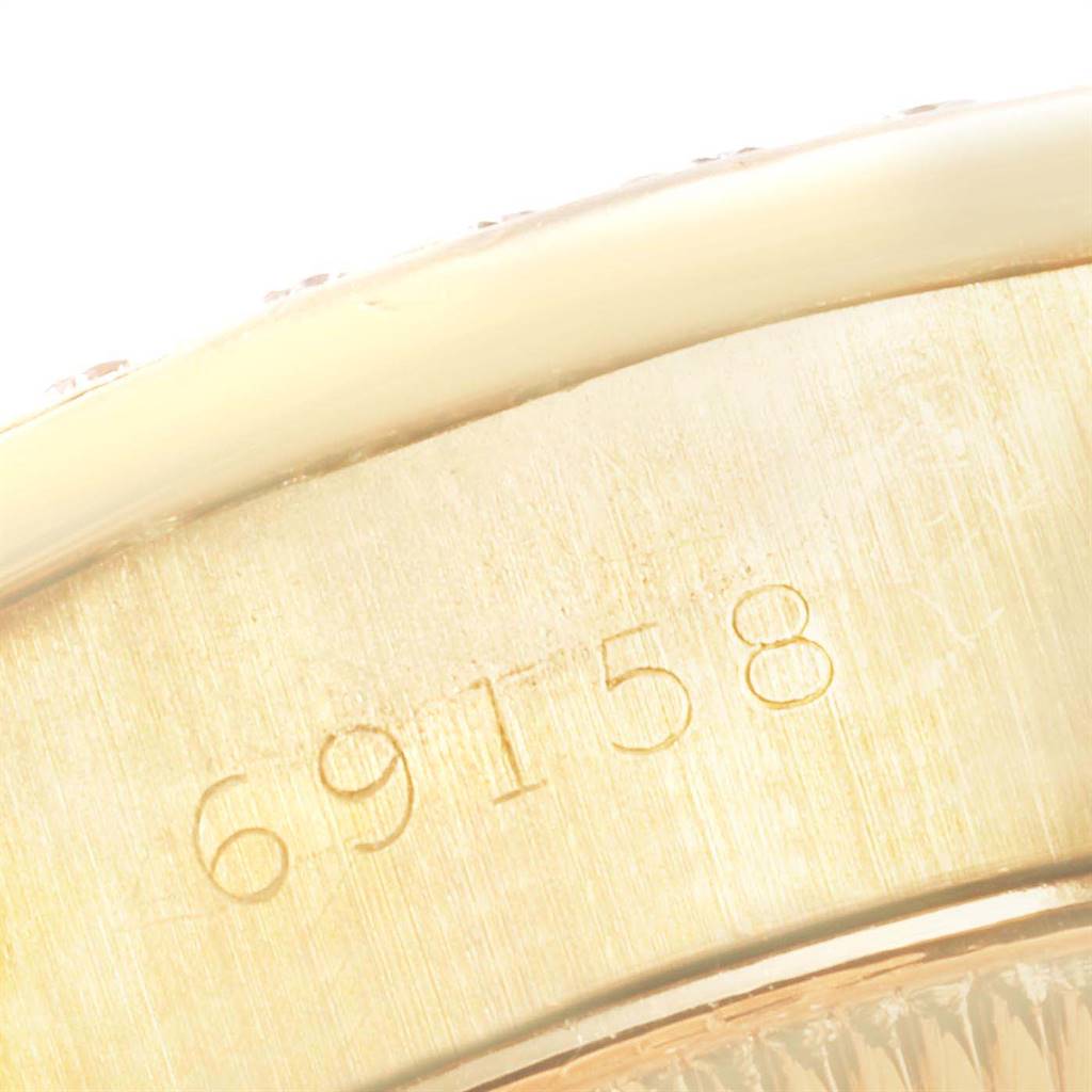 The image zooms in on the serial number "69158" engraved on the gold case of a Rolex President 69158 Women's Yellow Gold Silver Dial 69158 Women's Yellow Gold Silver Dial model watch.