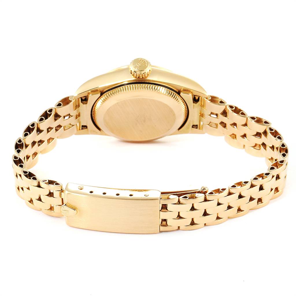 The image shows the back view of a Rolex President 67198 Women's Yellow Gold Black Dial 67198 Women's Yellow Gold Black Dial model watch, highlighting its case back, crown, and gold bracelet.