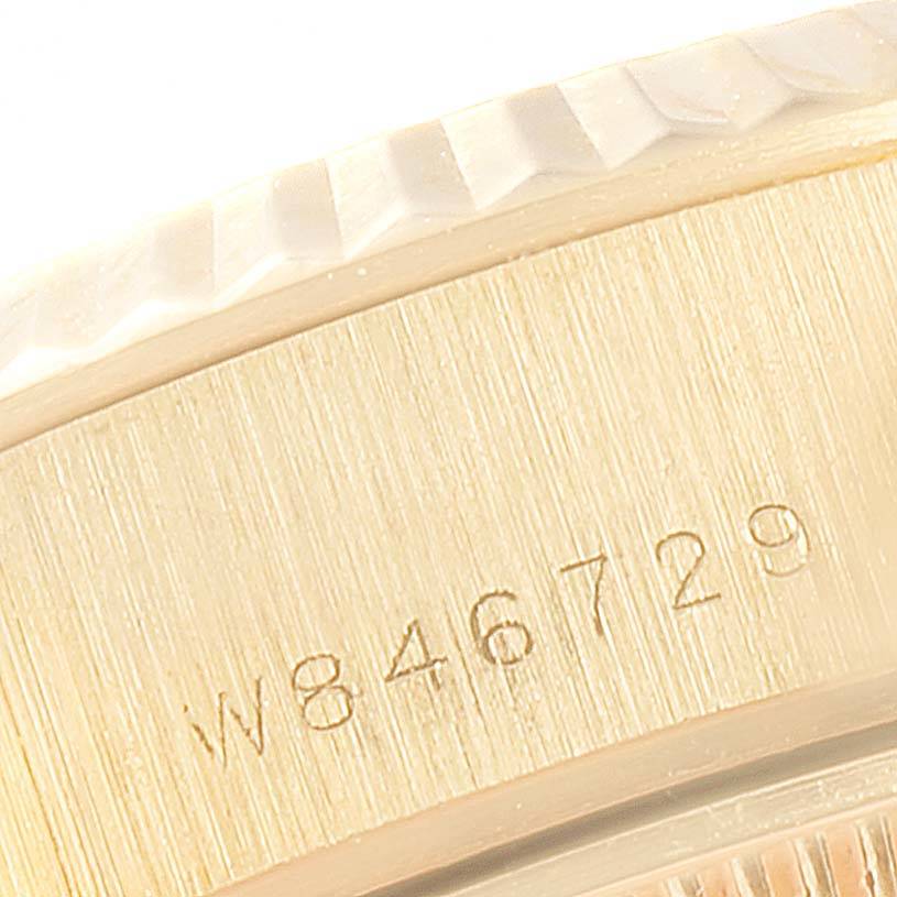 The image shows a close-up angle of the case side of a Rolex President 69178 Women
s Yellow Gold Champagne Dial 69178 Women
s Yellow Gold Champagne Dial model watch, highlighting its serial number engraving.