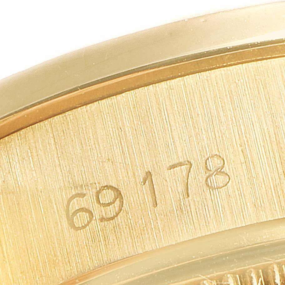This close-up image shows the serial number engraving on the case of a Rolex President 69178 Women's Yellow Gold Blue Dial 69178 Women's Yellow Gold Blue Dial model watch.