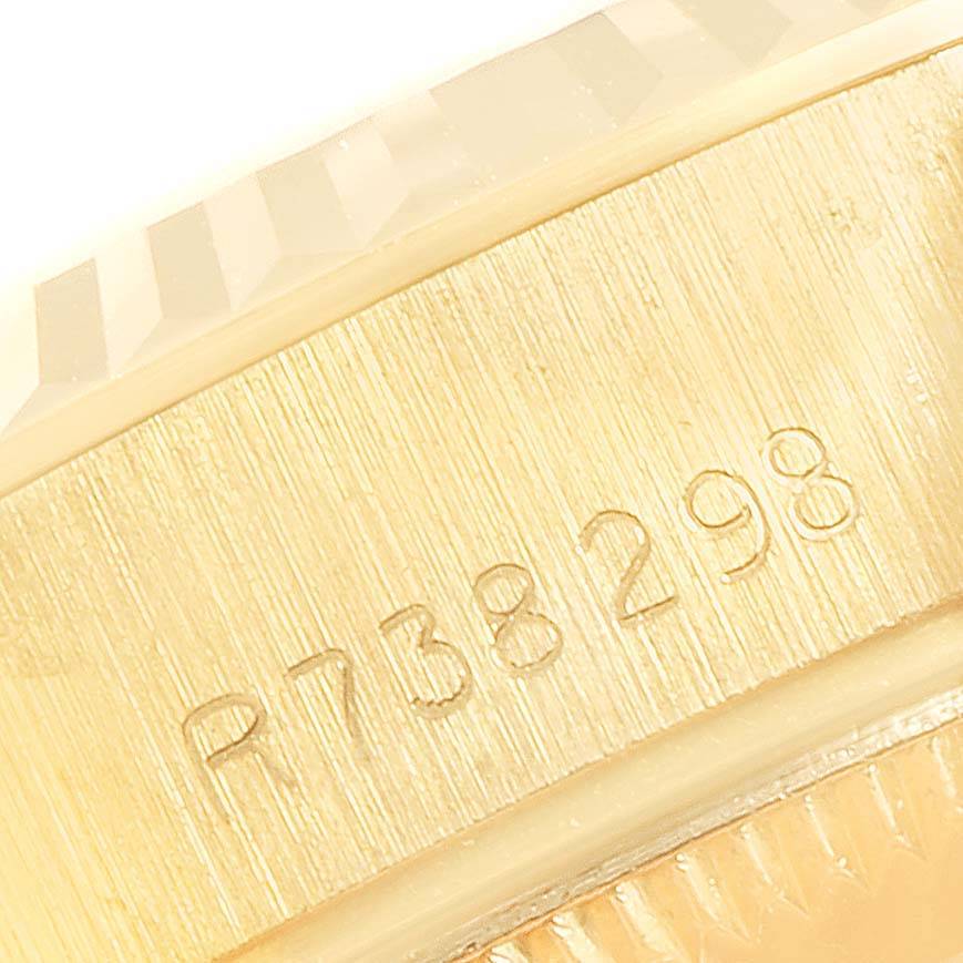 The image shows a close-up of the serial number engraved on the gold case of a Rolex President 69178 Women's Yellow Gold Blue Dial 69178 Women's Yellow Gold Blue Dial model watch.